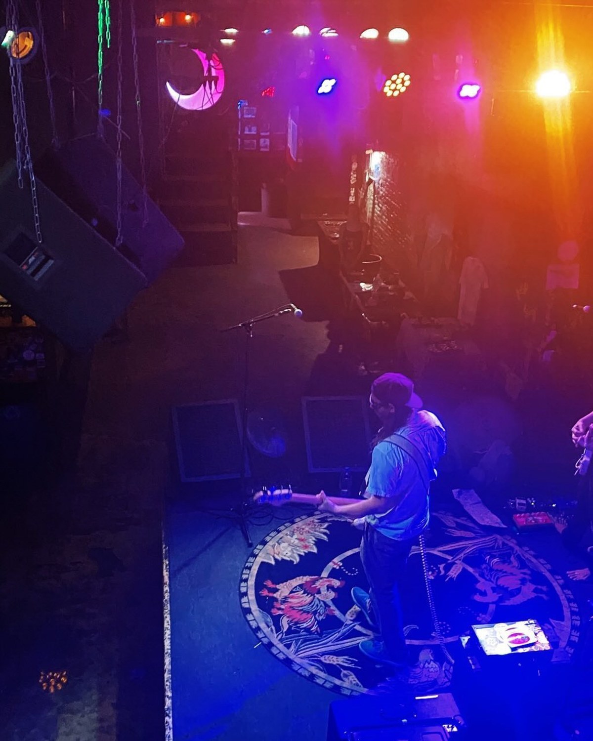 Overhead stage view with guitarist and lighting